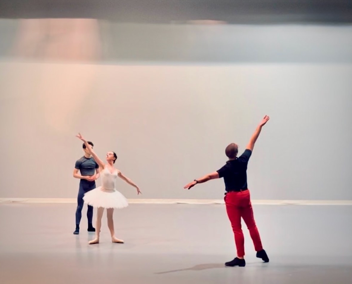 Ian Parsons physically demonstrates an arm movement as two dancers work beside him.